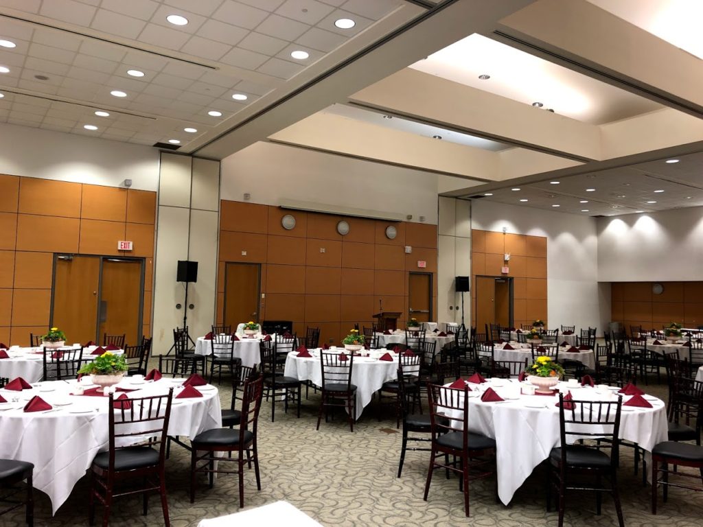 Image showing CIBC Hall set up for a banquet with round tables, chairs, tablecloths and complete table settings