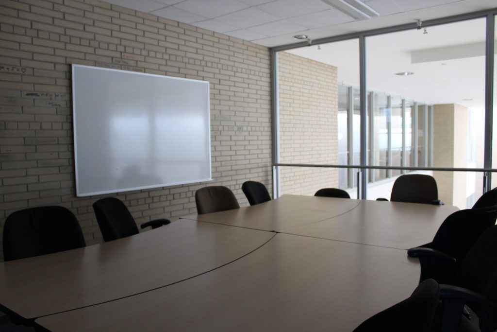 Image of a MUSC meeting room with one table and 12 chairs around